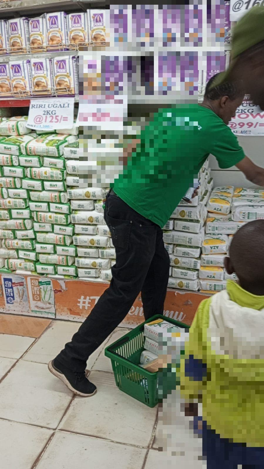 Merchandiser building a maize flour display in-store